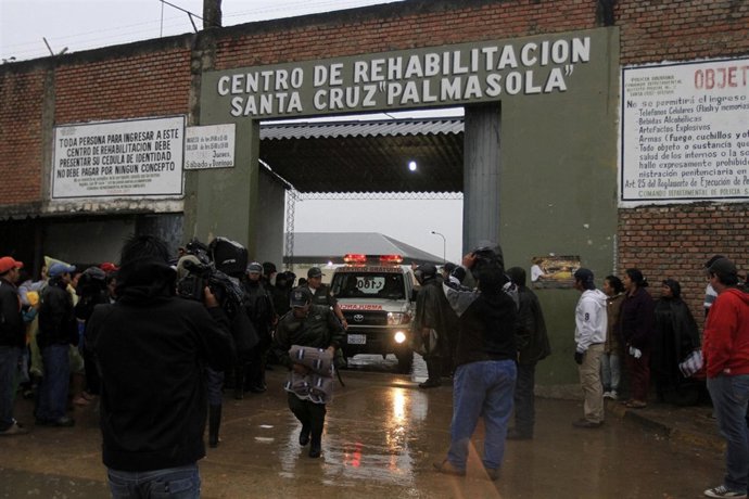 Relatives of inmates wait for news at the entrance of Palmasola Penitentiary