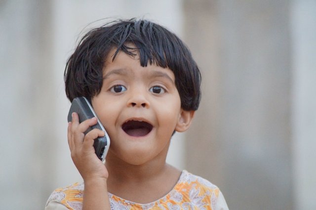 Niño hablando por teléfono móvil