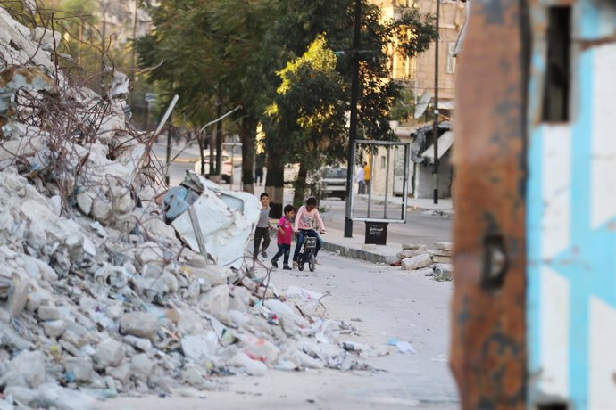 Unos niños juegan junto a un edificio destruido en Alepo