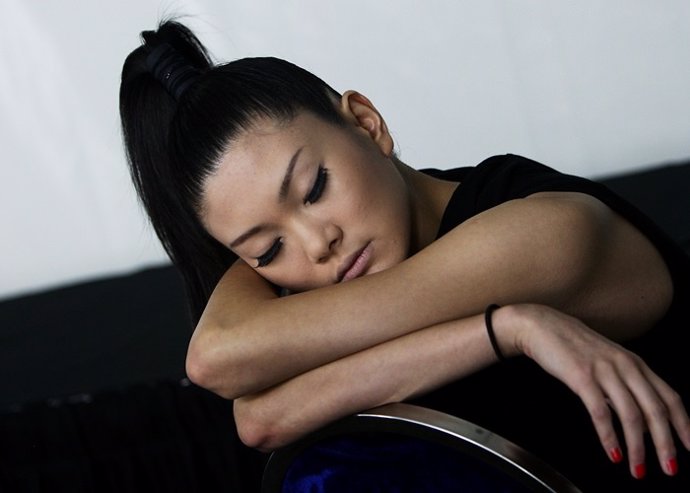 SINGAPORE - MAY 19:  A model sleeps backstage ahead of the Emanuel Ungaro show d