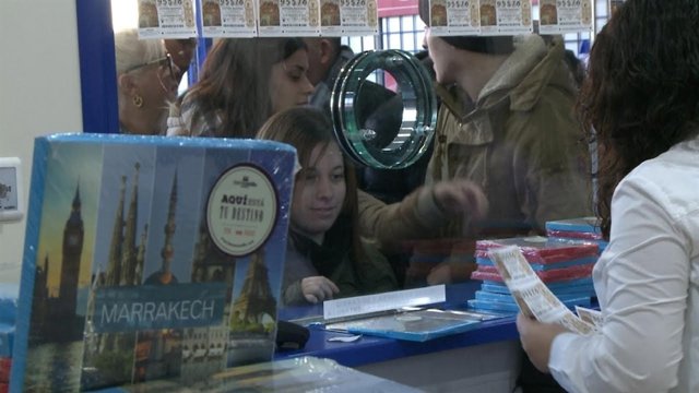 Una mujer compra el décimo que incluye las noches de hotel 