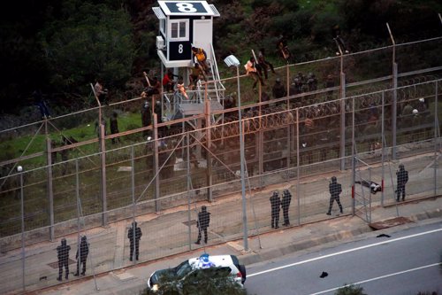 Inmigrantes entran en Ceuta a través de la valla que separa España de Marruecos