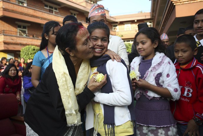 La presidenta de la Maiti, Anuradha Koirala, le da un beso a una niña en Napal.