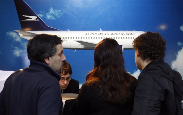 Passengers check in at a Aerolineas Argentinas desk at Buenos Aires' domestic ai