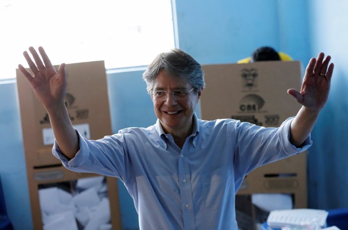 Guillermo Lasso, presidential candidate from the CREO party, waves before castin