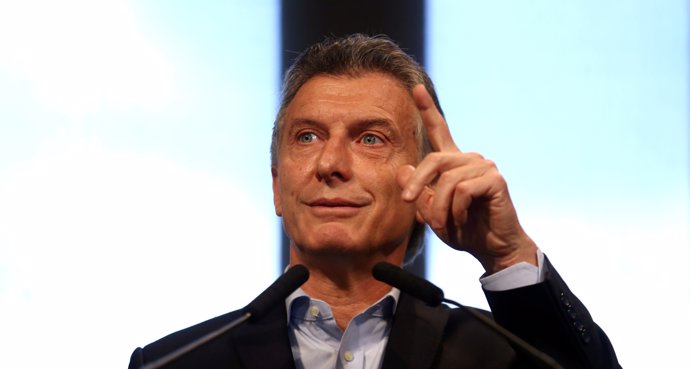 Argentine President Mauricio Macri gestures during a news conference at the Casa