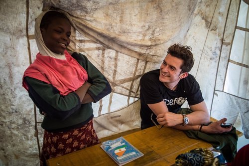 UNICEF Goodwill Ambassador Orlando Bloom (right) smiles as he listens to twelve-
