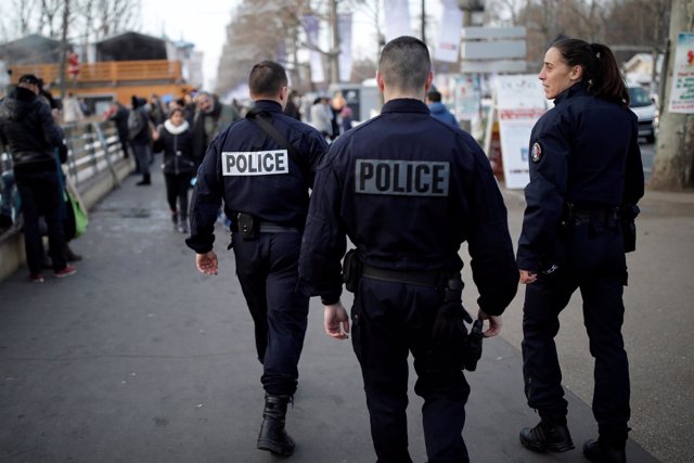 French police officers patrol a Christmas market on the Champs Elysees Avenue as