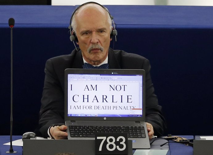Polish Member of the European Parliament Janusz Korwin-Mikke displays the slogan