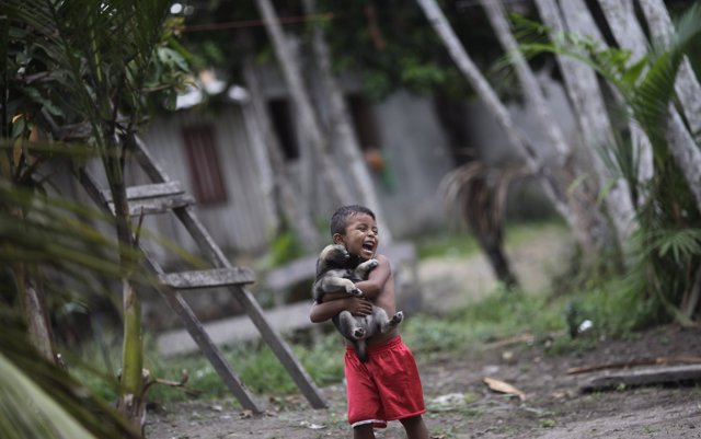 A boy holds his dog in Santa Izabel do Rio Negro, in Amazonas state, northern Br