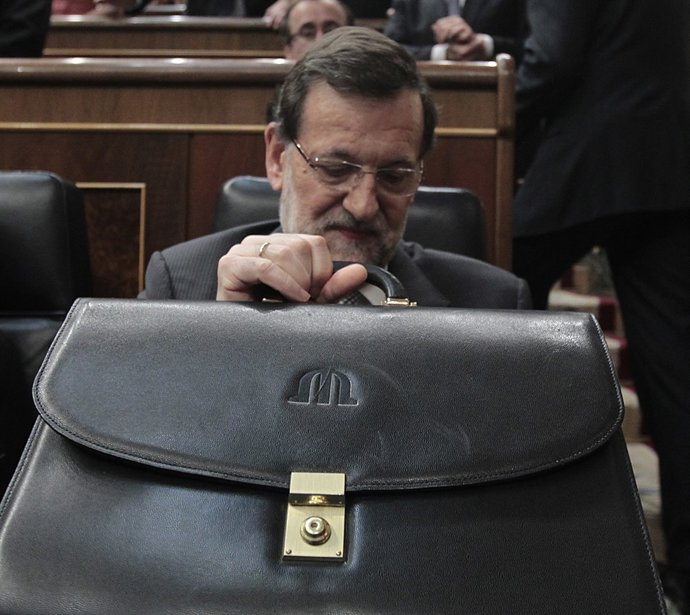 Rajoy amb la seva cartera en el seu escó del Congrés