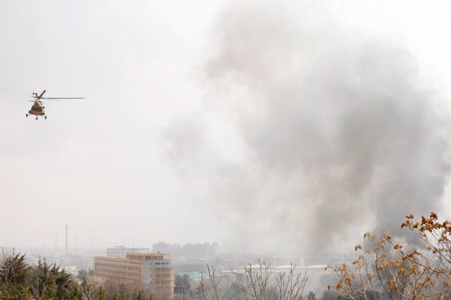 Smoke rises from a military hospital at the site of blast and gunfire in Kabul, 