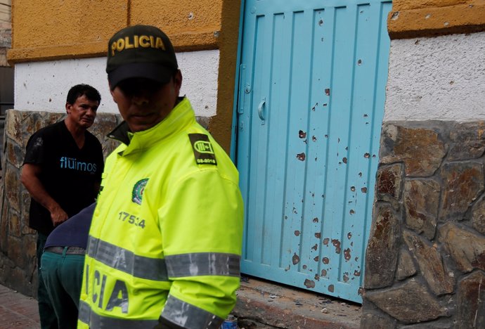 A police officer works the scene where an explosion occurred near Bogota's bullr