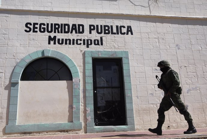 A soldier walks past the police headquarters where Marisol Valles Garcia used to