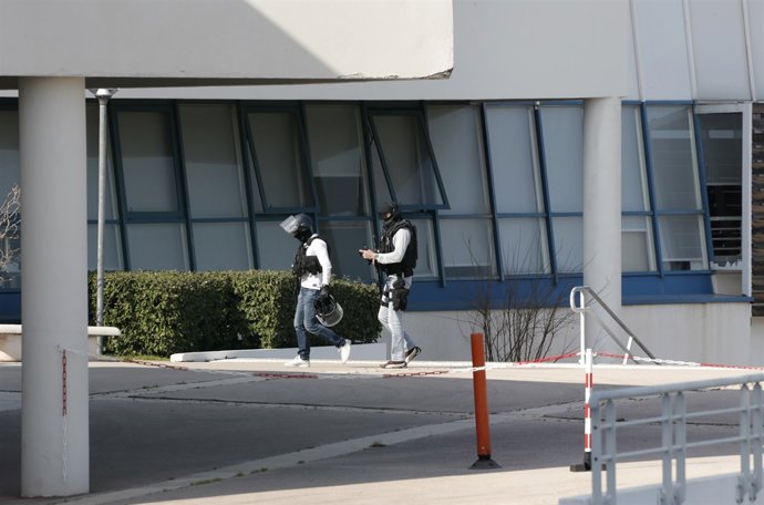 Police inside the Tocqueville high school after a shooting has taken place injur