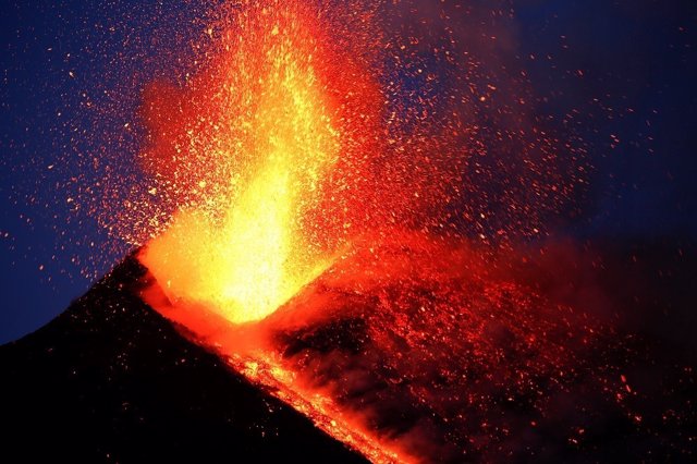Italy's Mount Etna, Europe's tallest and most active volcano, spews lava as it e