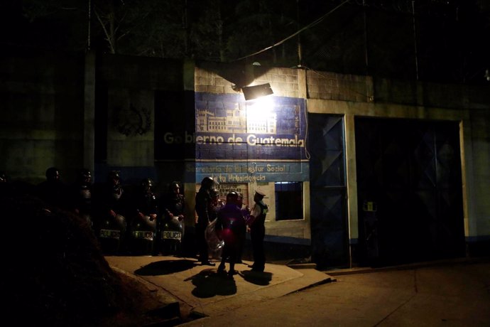 Policemen stand guard after a riot by underage inmates, outside the Correctional