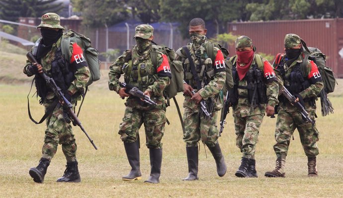 Defected members of Colombian guerrilla group ELN walk to a military base to sur