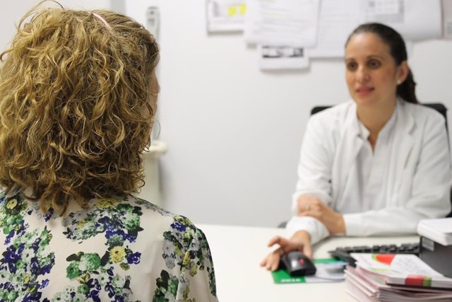Una doctora atiende a una mujer en un consulta