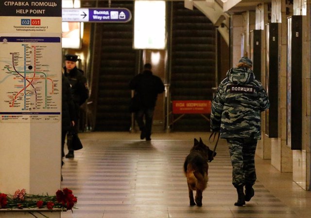 A police officer walks with a dog at Tekhnologicheskiy institut metro station in