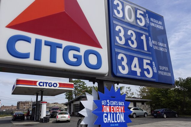 People fuel their cars at a Citgo gas station in Kearny, New Jersey September 24