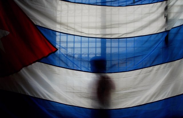 A Nicaraguan boy stands behind a Cuban flag during a mass to honor Cuba's Presid