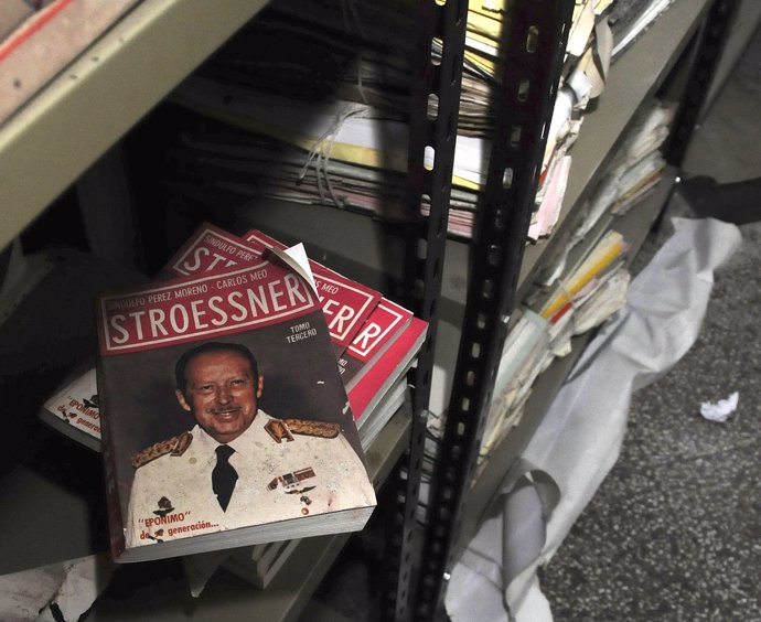A book with the picture of the dictator Alfredo Stroessner is seen from military
