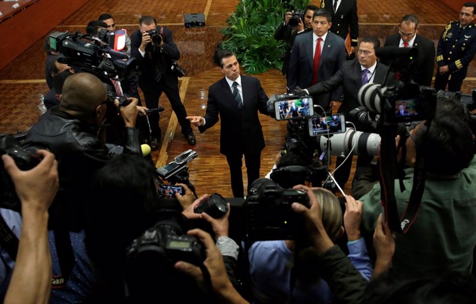 Mexico's President Pena Nieto talks to the media after giving a speech about sla