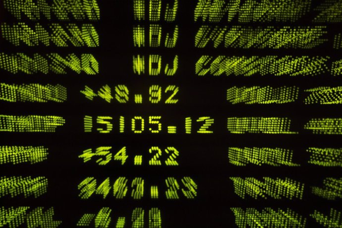 A screen displays the final tally for the Dow Jones industrial average, which ga