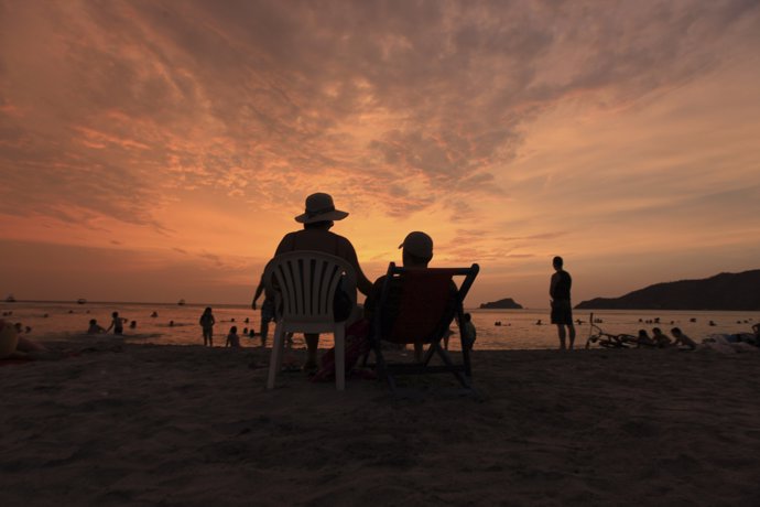 Tourists watch the sunset at El Rodadero beach, near the Caribbean port of Santa