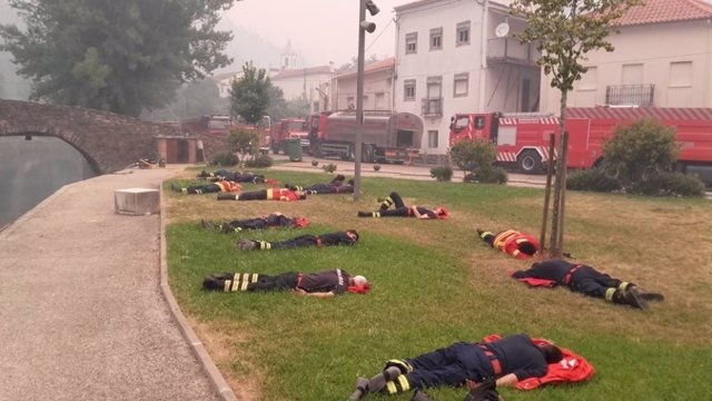 13 Exhasutos Bomberos Descansando En Su Lucha Con El Incendio De Portugal
