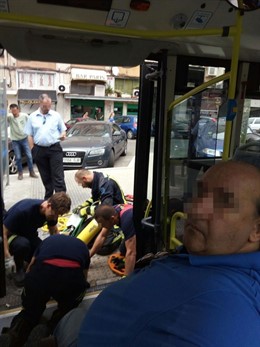 Bomberos ayudan a un discapacitado a bajar de un autobús