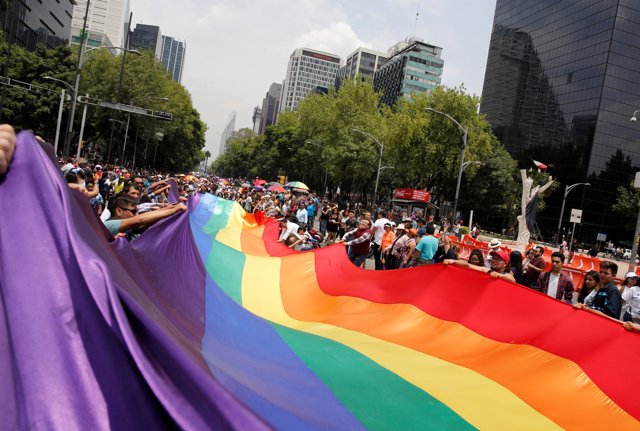 Participants carry a rainbow flag during the Gay Pride Parade in Mexico City, Me