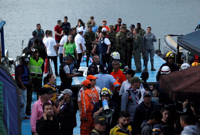 Rescuers wait at the dock after a tourist boat sank with 150 passengers onboard 