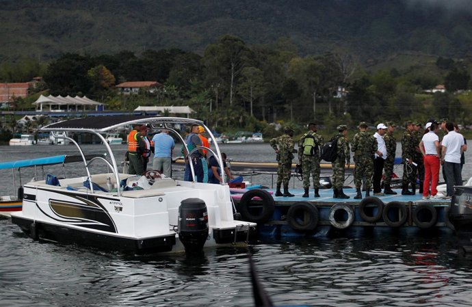 Rescuers wait at the dock after a tourist boat sank with 150 passengers onboard 