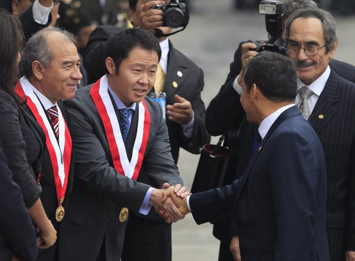 Peru's President-elect Ollanta Humala (R) greets congressman Kenji Fujimori, son