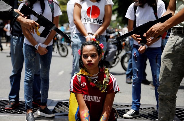 Demonstrators perform during a rally against Venezuela's President Nicolas Madur