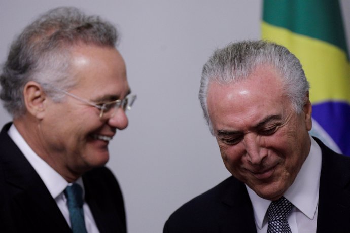 Brazil's President Michel Temer (R) smiles near senator Renan Calheiros, during 