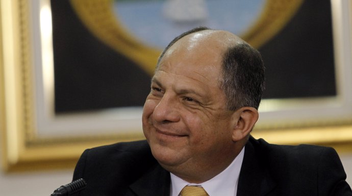 Costa Rica's President Luis Guillermo Solis smiles as his speaks to the media at
