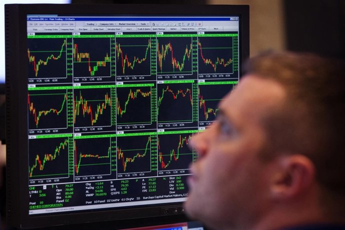 A trader works on the floor of the New York Stock Exchange after the closing bel