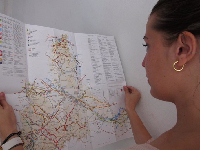 Una joven consulta un mapa turístico de la provincia de Zaragoza