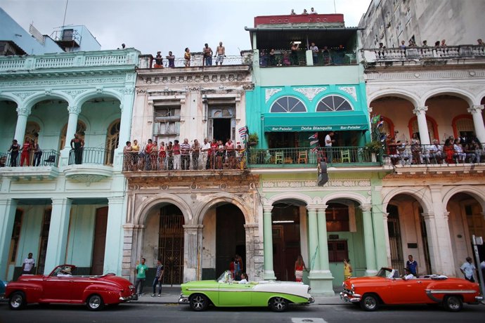 People stand on balconies prior to a fashion show displaying creations by German