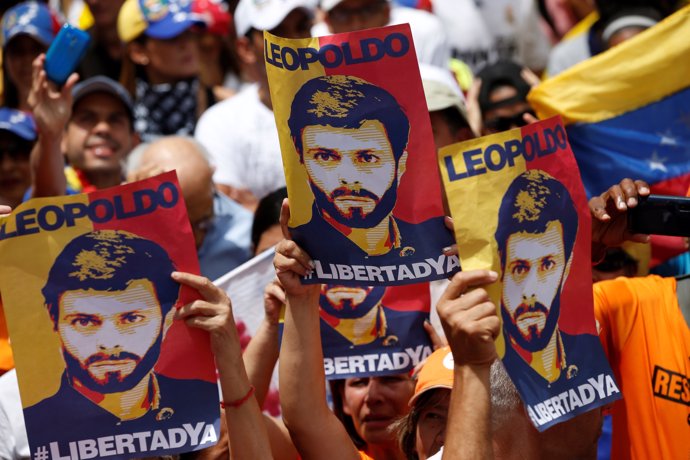 Placards depicting Venezuela's opposition leader Leopoldo Lopez, who has been gr