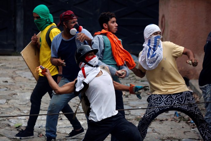 Demonstrators clash with riot security forces during a strike called to protest 