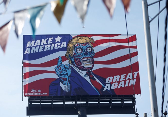 A giant billboard shows a drawing depicting U.S. President Donald Trump, along P