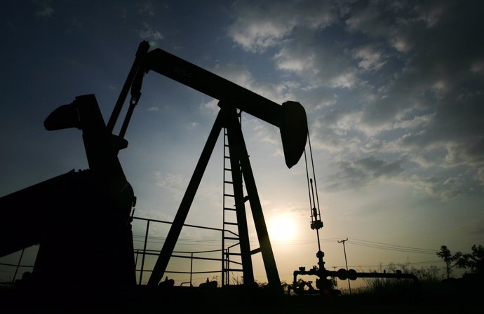 A pump jack is seen during sunset at Lagunillas field in the eastern coast of La