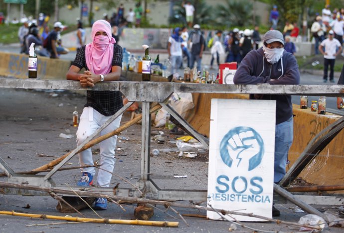 Demonstrators man a barricade after clashes broke out while the Constituent Asse