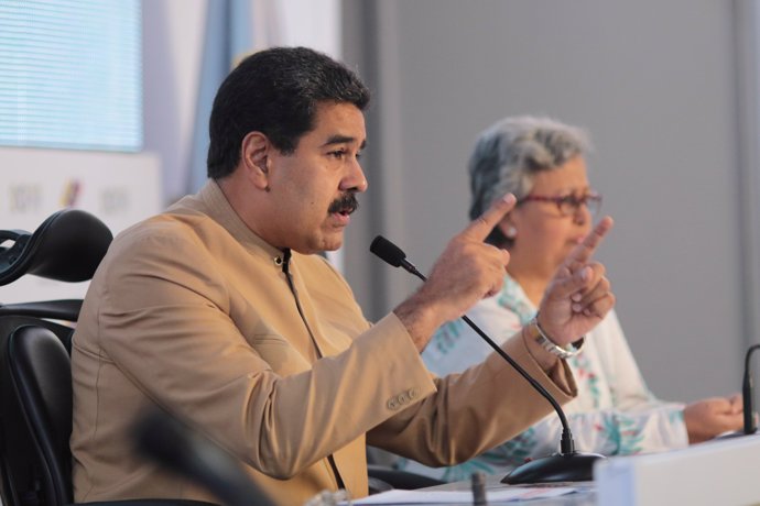 Venezuela's President Nicolas Maduro (L) speaks next to National Electoral Counc
