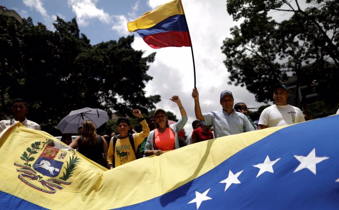 Pro-government supporters holding Venezuela's flag march in Caracas, Venezuela A