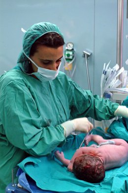 Una profesional sanitaria atiende a un bebé recién nacido.